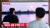 FILE - A man watches a TV showing a file image of a North Korea missile launch with leader Kim Jong Un looking on, during a news program at the Seoul Railway Station in Seoul, South Korea, Aug. 6, 2019.