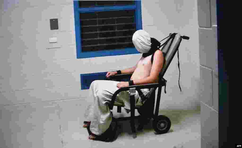 This frame grab from Australian Broadcasting Corporation&#39;s (ABC) Four Corners program broadcast on July 25, 2016, allegedly shows a teenage boy hooded and strapped into a chair at a youth detention center in the Northern Territory city of Darwin. The Australian government ordered an inquiry after graphic evidence emerged of prison guards assaulting teenage boys, with one shown hooded and shackled in scenes likened to Guantanamo Bay.