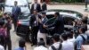 Nepal's Prime Minister K.P. Sharma Oli, center, greets Cambodian government officials upon his arrival at Cambodian National Museum in Phnom Penh, Cambodia, Tuesday, May 14, 2019.