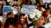 FILE - Relatives of victims of then-President Rodrigo Duterte's so-called war on drugs hold a memorial for their loved ones, at a church in Manila, Philippines, March 17, 2019. 
