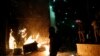FILE - Protesters set fires at the 3rd Precinct of the Minneapolis Police Department, May 28, 2020, in Minneapolis, Minnesota. 
