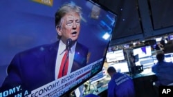 A television screen on the floor of the New York Stock Exchange shows President Donald Trump's speech to the Economic Club of New York, Nov. 12, 2019. 
