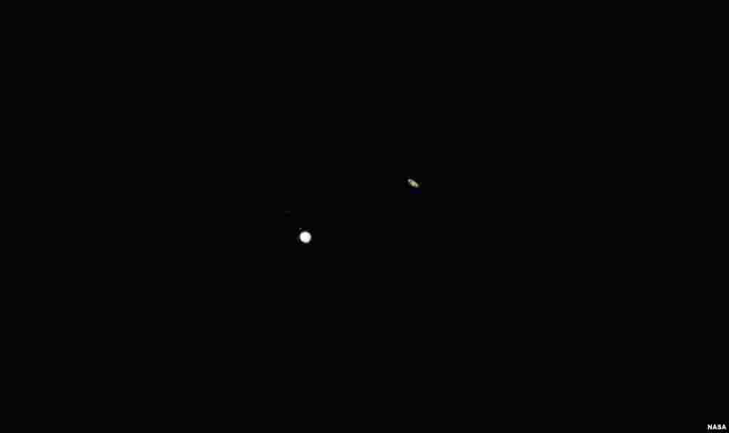 Jupiter, left, and Saturn, right, are seen during the &ldquo;great conjunction&rdquo; where the two planets appear a tenth of a degree apart from one another, Dec. 21, 2020, near Chapel Hill, North Carolina.