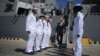 Ukrainian Prime Minister Arseniy Yatsenyuk, center, leaves the USS Donald Cook, the Navy's newest missile cruiser, and passes by the guard of honor in Odessa, Ukraine, Sept. 1, 2015.