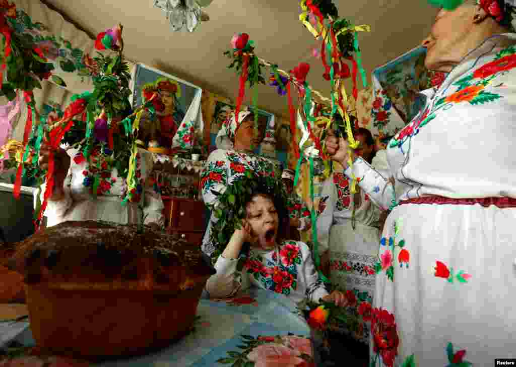 Villagers take part in a ritual celebrating the pagan god Yurya and pray for plentiful future harvests in the village of Pogost, Belarus.
