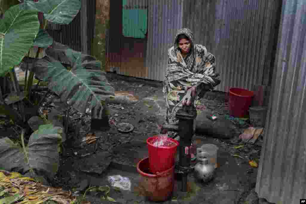 Bangladeshi woman collects arsenic-tainted water from a tube-well in Khirdasdi village, on the outskirts of Dhaka, Bangladesh, April 5, 2016. A new report estimates that some 20 million Bangladeshis are still being poisoned by arsenic-tainted groundwater drawn from government wells.