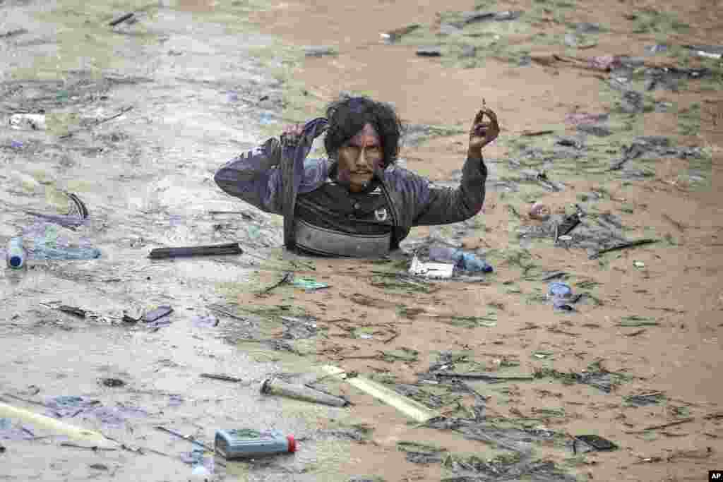 A man wades through flood water following heavy downpours in Medan, North Sumatra, Indonesia, Nov. 27, 2024. 