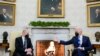 President Joe Biden, right, gestures during a meeting with German Chancellor Olaf Scholz in the Oval Office of the White House, in Washington, Feb. 7, 2022.