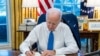 U.S. President Joe Biden signs an executive order to prohibit trade and investment between U.S. individuals and the two breakaway regions of eastern Ukraine recognized as independent by Russia, at the White House in Washington, Feb. 21, 2022. (White House / Handout via Reuters)