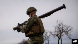 A U.S. Marine carries a Stinger air defense missile launcher during training in Romania, March 20, 2017. 