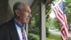In this Friday, July 12, 2013 photo, retired U.S. Navy Capt. Thomas Hudner, who was awarded the Medal of Honor by President Truman, poses on the porch at his home in Concord, Mass. 