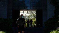 FILE - Students make their way through the University of Chicago campus, in Chicago, May 6, 2021.
