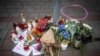 FILE - Candles and flowers have been placed on the pavement outside a gay bar where two men were shot dead the night before, in Bratislava, Slovakia, on Oct. 13, 2022. The attack was linked to the Terrorgram group, an extreme right-wing online network.