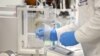 FILE - A chemist works at AstraZeneca's headquarters, in Sydney, Australia. AstraZeneca has a deal with Australia to produce and distribute a vaccine being developed by Britain's Oxford University.