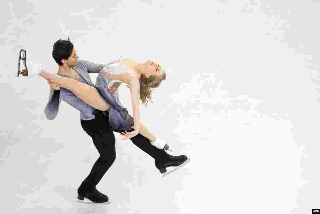 Kaitlyn Weaver and Andrew Poje of Canada skate during a practice session before the start of the ISU World Figure Skating Championships at TD Garden in Boston, Massachusetts, USA.