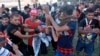 An injured protester is rushed to the hospital after being shot during a demonstration in Baghdad, Iraq, Oct. 4, 2019.