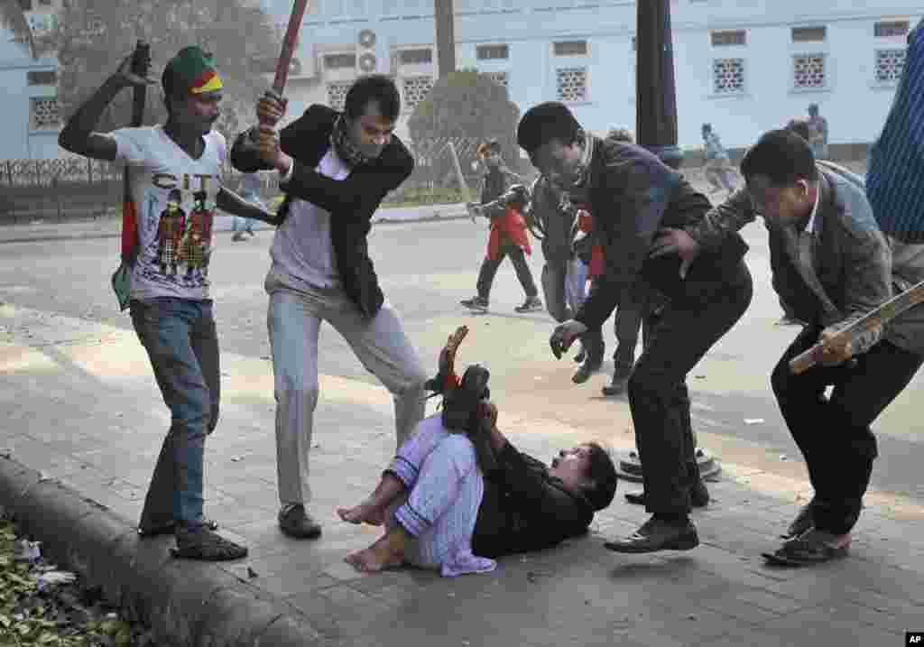 Supporters of the ruling Bangladesh Awami League beat a lawmaker and supporter of the main opposition Bangladesh Nationalist Party (BNP) during a protest by opposition activists in Dhaka, Bangladesh, Dec. 29, 2013. Security forces and opposition activists clashed in the capital, leaving at least one person dead, as thousands of police took to the streets to foil a mass rally calling on Prime Minister Sheikh Hasina to cancel upcoming elections.