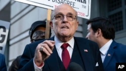 FILE - Rudy Giuliani speaks during a news conference outside federal court in Washington, Dec. 15, 2023. 