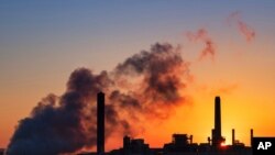 FILE - The Dave Johnson coal-fired power plant is silhouetted against the morning sun in Glenrock, Wyo. 