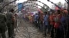 In this file photo, taken on Dec. 30, 2013, Cambodian garment workers, right, are blocked by barbed wire set up by police near the Council of Ministers building during a rally in Phnom Penh, Cambodia. (AP Photo/Heng Sinith)