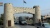 A security escort vehicle followed by a truck load of supplies drive past Khayber pass November 17, 2008. Pakistani security forces escorted a truck convoy carrying supplies for Western forces in Afghanistan on Monday as Pakistan reopened the Khyber Pass 