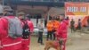 In this photo released by the Indonesian National Search and Rescue Agency, rescuers prepare to head out to the site of a landslide that killed a number of people, in Suwawa on Sulawesi Island, Indonesia, July 8, 2024. 