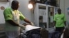 A doctor (L) performs circumcision on an unidentified politician in an effort to reduce the spread of HIV, in Harare, Zimbabwe, June 22, 2012.