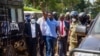 Ugandan musician turned politician Robert Kyagulanyi, also known as Bobi Wine, raises his arm as he walks to the court in Inganga, Nov. 19, 2020.