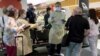 FILE - Arriving passengers are screened by health workers at the airport in Sydney, Australia, Feb. 12, 2021. The first repatriation flight carrying Australians from coronavirus-hit India has arrived in Darwin Saturday.