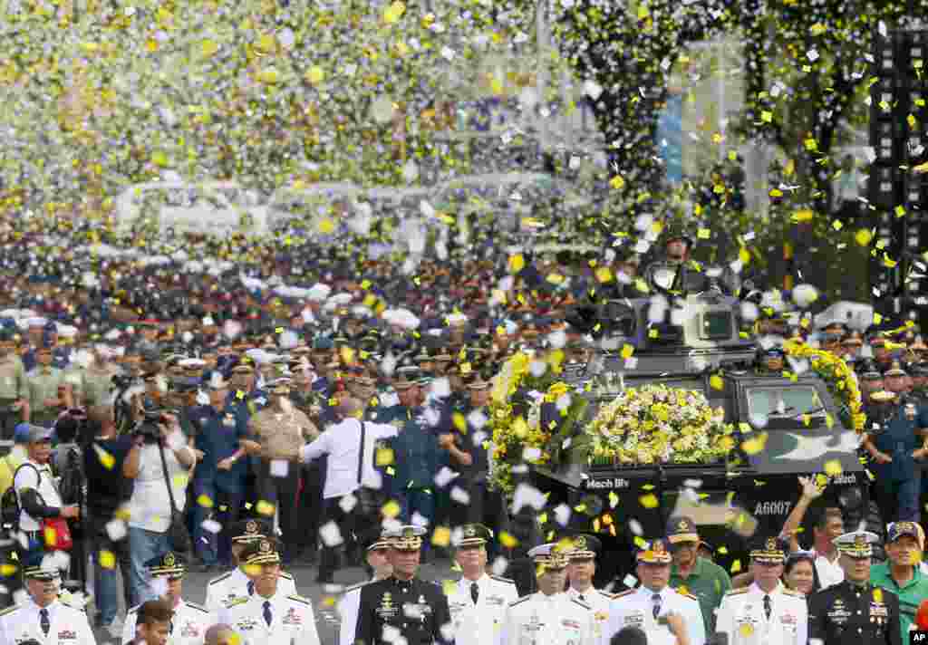 Yellow confetti rain on the military component during the 30th anniversary celebration at suburban Quezon city, northeast of Manila, the Philippines, of the &quot;People Power Revolution&quot; that toppled the 20-year-rule of the late strongman Ferdinand Marcos.
