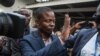 Malawian preacher Shepherd Bushiri waves at supporters as he leaves the Lilongwe Magistrate court, in Lilongwe, Malawi, Nov. 19, 2020.
