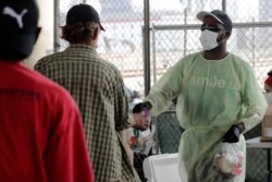 Melvin Armstrong, of the Smile Trust hands out meals and cold drinks to the homeless during the new coronavirus pandemic on April 3, 2020, in the Overtown neighborhood of Miami, Florida, United States.