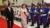 Cambodia's Prime Minister Hun Sen, left, reviews an honor guard with Myanmar's State Counselor Aung San Suu Kyi at the Peace Palace in Phnom Penh, Cambodia, Tuesday, April 30, 2019. (AP Photo Heng Sinith)