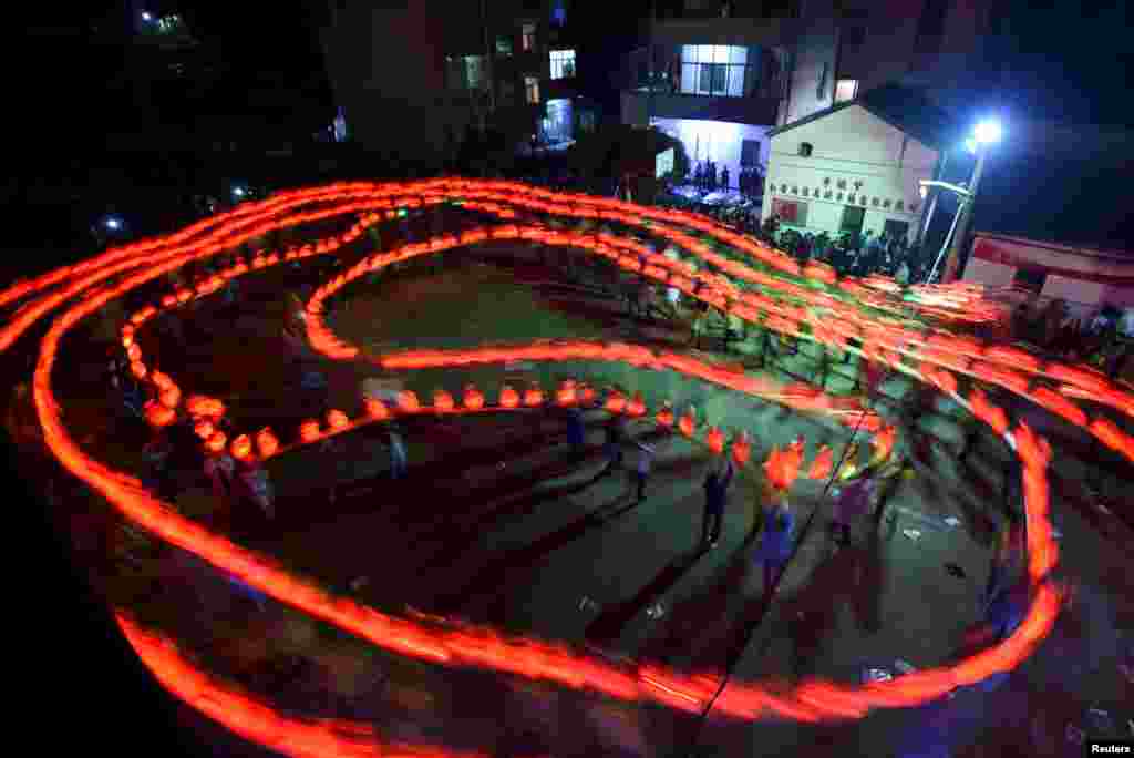 Children holding lanterns parade ahead of the Qingming Festival, or the Tomb Sweeping Day in Yiwu, Zhejiang province, China, April 2, 2016.