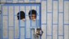A patient looks from behind bars at a psychiatric hospital during a ceremony marking the World Mental Health Day in Sanaa, Yemen October 10, 2019. 