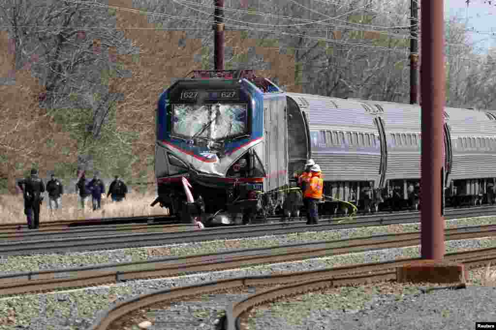 Emergency personnel examine the scene after an Amtrak passenger train struck a backhoe, killing two people, in Chester, Pennsylvania.&nbsp;The southbound Palmetto train running from New York to Savannah, Georgia, had about 341 passengers and seven crew members aboard when it struck the backhoe.&nbsp;
