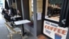 FILE - Customers eat in a cafe in Sydney, Australia, after more than seven weeks of COVID-19 restrictions on May 15, 2020.