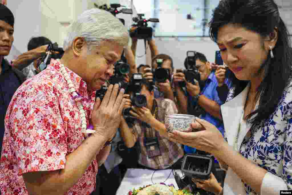 Former Thai Prime Minister Yingluck Shinawatra weeps as she takes part in Songkran festival celebration with opposition Puea Thai party members at the party headquarters in Bangkok.