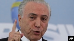FILE - Brazil's President Michel Temer speaks at the Planalto Presidential Palace, in Brasilia, Brazil, April 27, 2018.