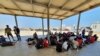 Rescued migrants rest near the city of Khoms, around 120 kilometers (75 miles) east of Tripoli, Libya, Aug. 27, 2019.