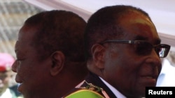 Zimbabwean President Robert Mugabe (R) and Prime Minister Morgan Tsvangirai in Harare, April 18, 2011. 
