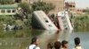 People stand by the wreckage after a locomotive crashed into the tail of the Cairo-bound passenger train in southern Egypt, in the province of Minya, about 168 miles south of Cairo, Oct. 13, 2024. 