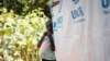 FILE - A young girl stands by her shelter at a camp for internally displaced people (IDPs) in Kaya, Burkina Faso, Oct. 14, 2020.