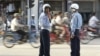 In this photo taken on Nov. 2, 2002, Cambodian police redirect traffic in Phnom Penh, Cambodia.