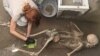 An archaeologist works on the recently discovered remains of a victim in the archaeological site of the ancient city of Pompeii, which was destroyed in AD 79 by the eruption of Mount Vesuvius, in Pompeii Italy, July 5, 2024. Parco Acheologico di Pompei/Handout via REUTERS 