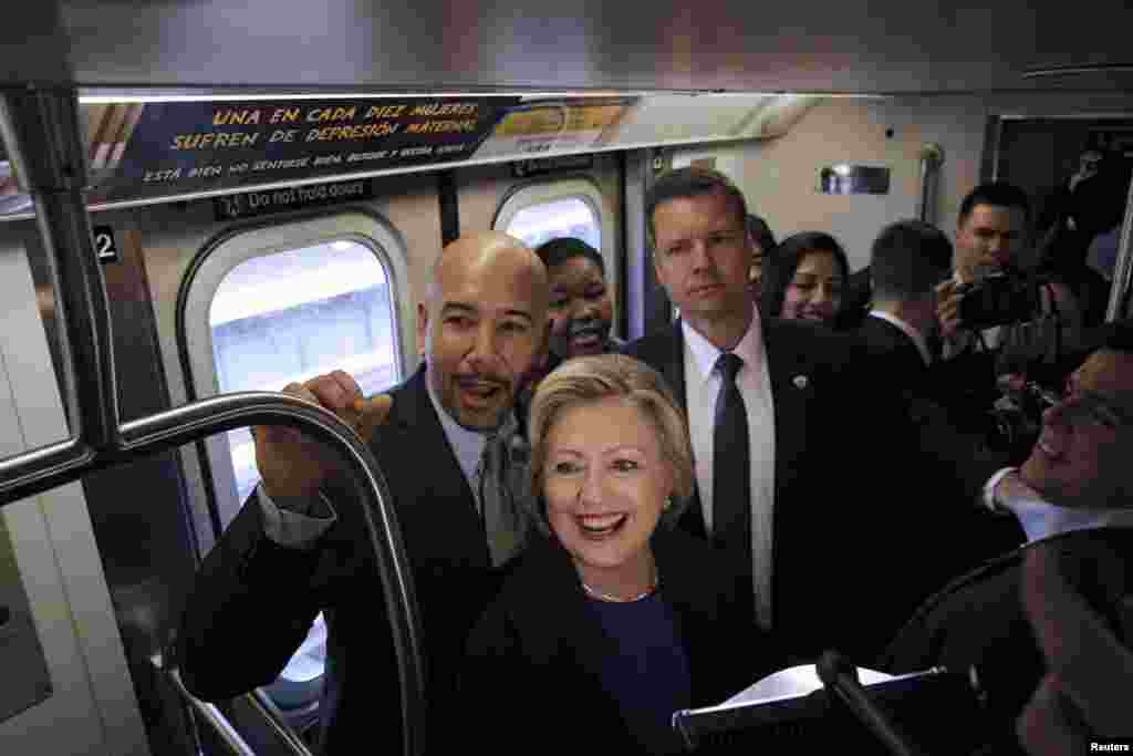 U.S. Democratic presidential candidate Hillary Clinton (C) rides the New York City Subway with Bronx Borough President Ruben Diaz (L).