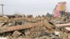 FILE - A Pakistani student stands near remains of a girls school destroyed by alleged militants in Dera Ismail Khan, Pakistan, Feb 3, 2012. Bombing of girls schools is a usual practice of militants fighting against government forces in Pakistan. 