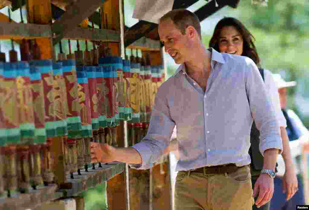 Britain's Prince William, Duke of Cambridge and his wife Catherine, Duchess of Cambridge, spin prayer wheels at the Paro Taktsang Monastery, Bhutan. The royal couple are on a seven-day tour of India and Bhutan.