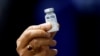 Indian Health Minister Harsh Vardhan holds a dose of Bharat Biotech's COVID-19 vaccine called COVAXIN, during a vaccination campaign at All India Institute of Medical Sciences (AIIMS) hospital in New Delhi, India, January 16, 2021. REUTERS/Adnan Abidi