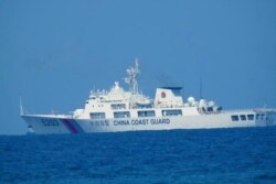 A Chinese Coast Guard patrol ship is seen at South China Sea, in a handout photo distributed by the Philippine Coast guard, April 15, 2021.